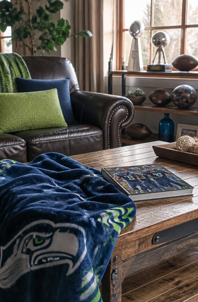 Living room with a Seahawks throw blanket and playoff guide on the table.